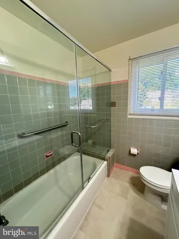 a bathroom with a bathtub and a toilet