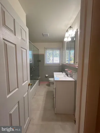 a view of bathroom with a sink and mirror with bathtub