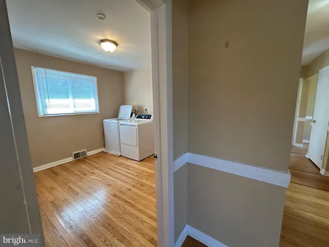a view of a room with wooden floor and chair