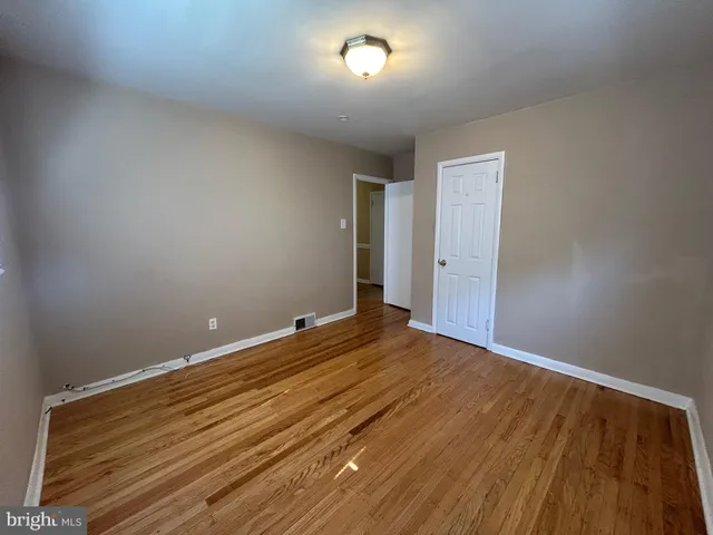 a view of room with wooden floor