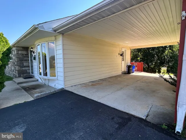 a view of a patio with table and chairs and a barbeque