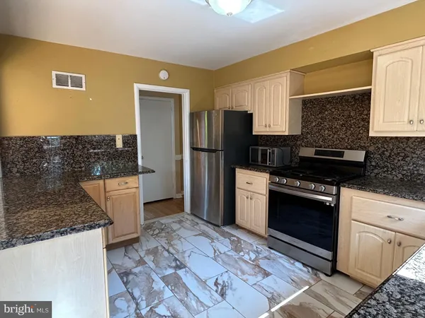a kitchen with a refrigerator stove and sink