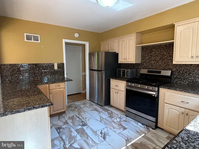 a kitchen with a refrigerator stove and sink