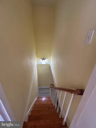 a view of a patio with wooden floor chairs and a yard