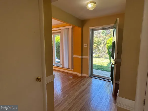 a view of an entryway with wooden floor