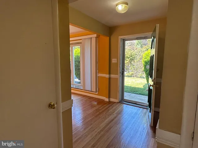 a view of an entryway with wooden floor