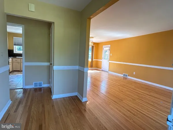 wooden floor in a hall with an empty room
