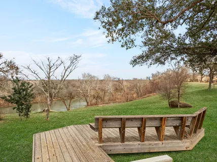 a view of a house with pool and chairs