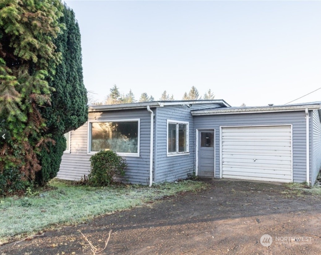 10915 Sandridge Road Long Beach, WA 98631 - Photo 1 of 1 a view of a house with a yard and garage