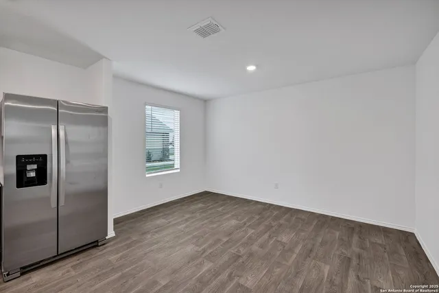 a view of a refrigerator in kitchen and wooden floor