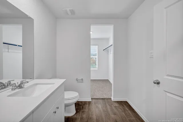 a bathroom with a sink a toilet and a mirror