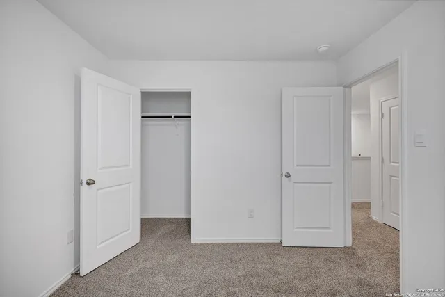 an empty room with closet area