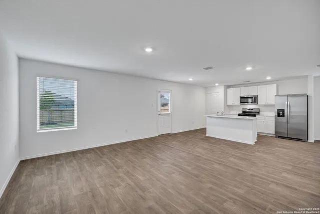 a view of kitchen with wooden floor and windows