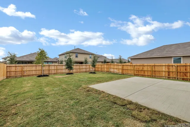a view of backyard of house with green space