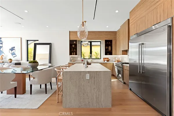 a kitchen with a sink and living room view
