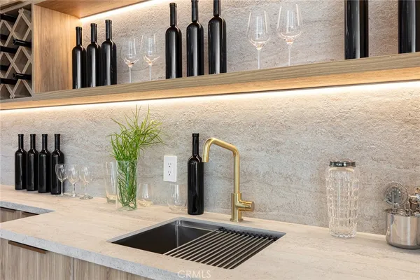 a living room with stainless steel appliances kitchen island granite countertop furniture and a large window