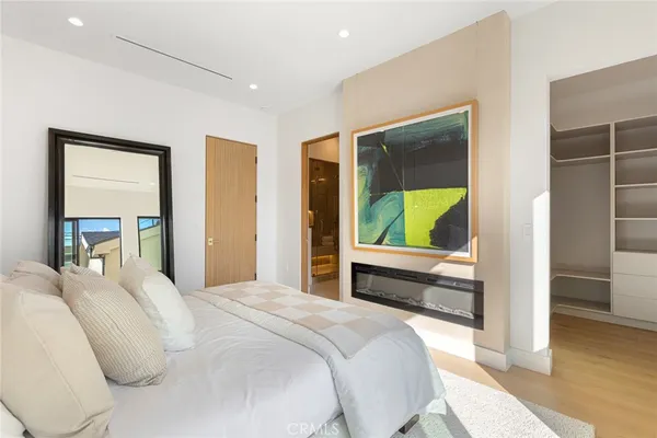 a bedroom with a bed and a floor to ceiling window