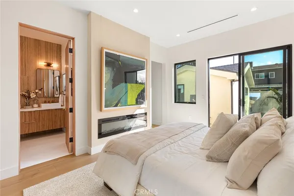 a bedroom with a bed and a large mirror