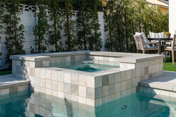 a view of a house with backyard sitting area and garden