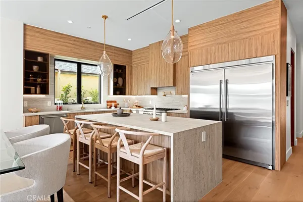 a kitchen with a center island a sink cabinets and stainless steel appliances