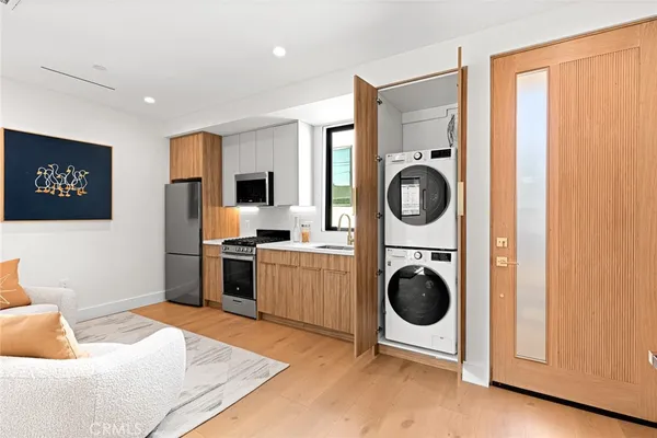 a bedroom with a bed and a lamp on dresser