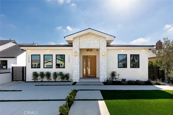a front view of house with yard and green space