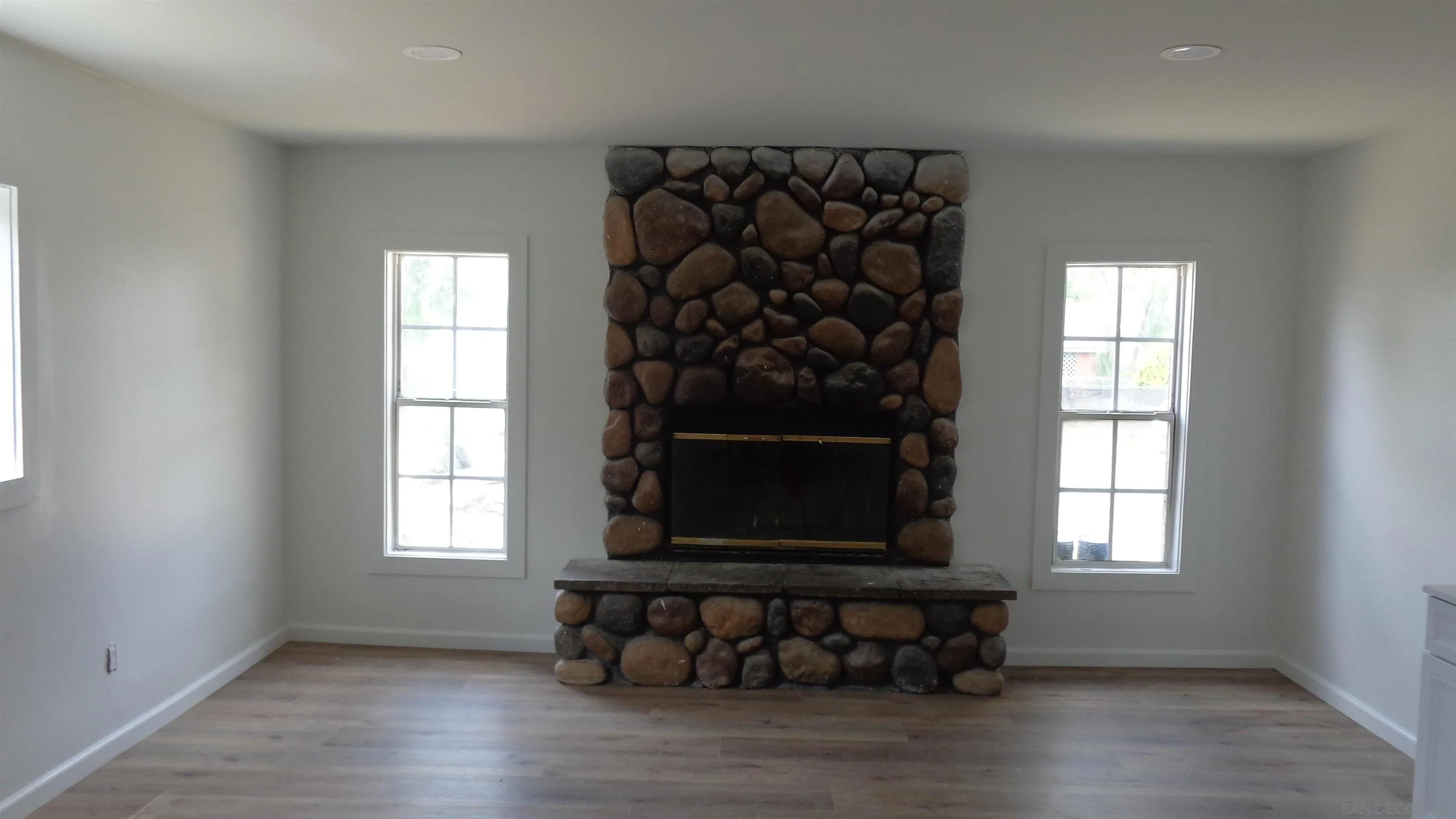 29660 Wilkes Road Valley Center, CA 92082 - Photo 2 of 16 an empty room with wooden floor and a window
