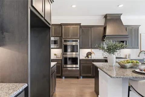 a kitchen with sink stove and cabinets