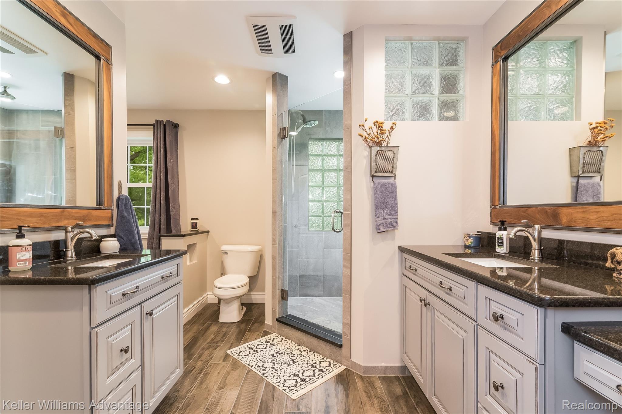 5385 Mack Road Howell, MI 48855 - Photo 9 of 59 Master suite bathroom with his and hers vanities and oversized walk-in shower. Also featuring his and hers walk-in closets.