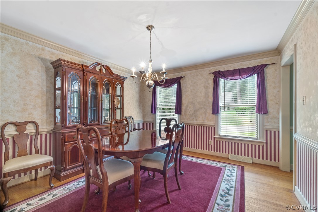 5609 North Chase Road Midlothian, VA 23112 - Photo 13 of 43 a dining room with furniture a chandelier and wooden floor