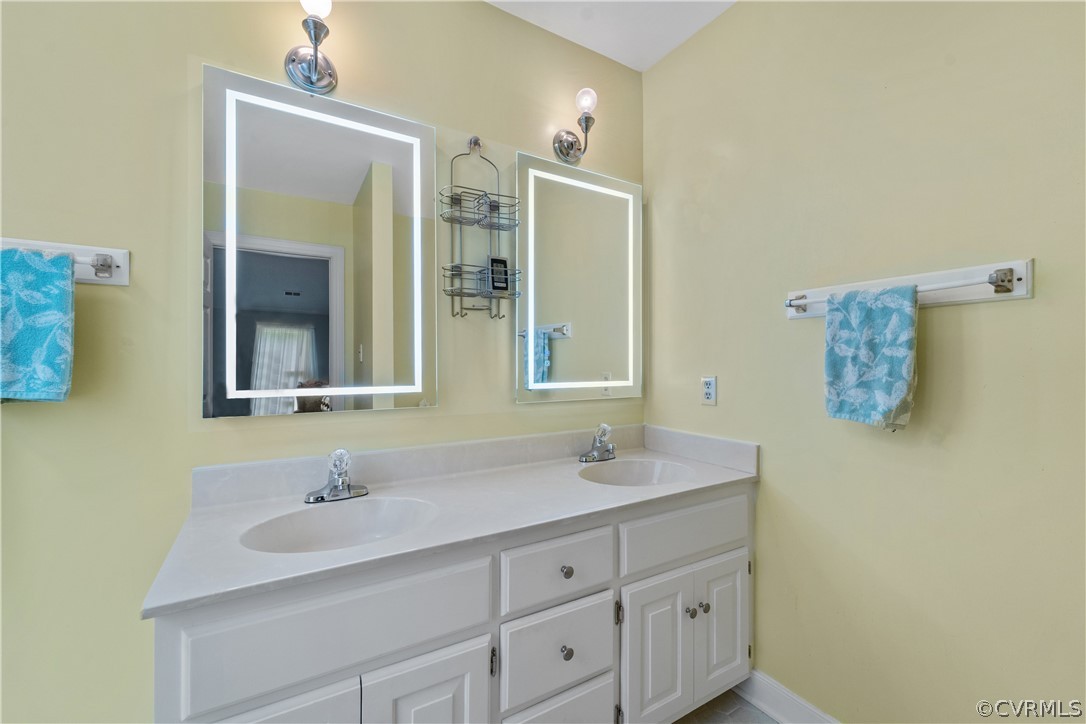 5609 North Chase Road Midlothian, VA 23112 - Photo 23 of 43 a bathroom with a sink and a mirror