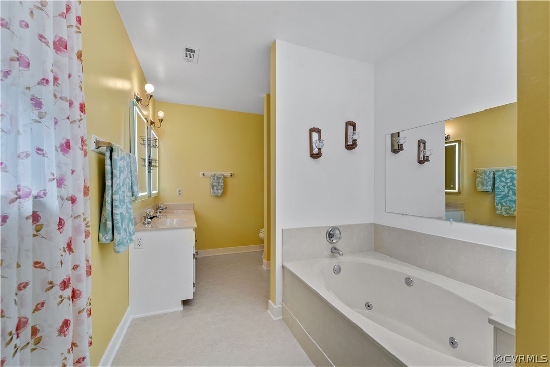 5609 North Chase Road Midlothian, VA 23112 - Photo 25 of 43 a bathroom with a bathtub sink and toilet