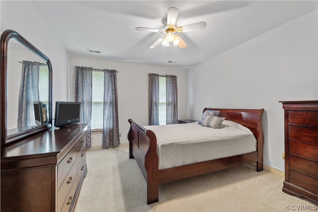 5609 North Chase Road Midlothian, VA 23112 - Photo 28 of 43 a bedroom with a large bed a chandelier and dresser