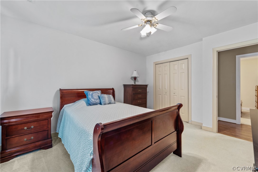 5609 North Chase Road Midlothian, VA 23112 - Photo 29 of 43 a bedroom with a bed and a chandelier