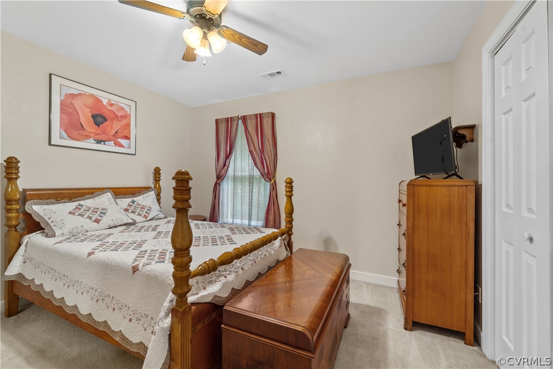 5609 North Chase Road Midlothian, VA 23112 - Photo 30 of 43 a bedroom with bed and a chandelier