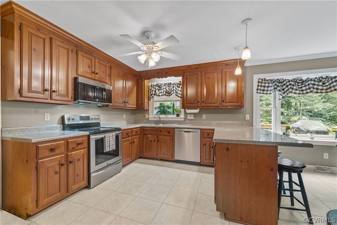 5609 North Chase Road Midlothian, VA 23112 - Photo 4 of 43 a kitchen with stainless steel appliances granite countertop wooden cabinets a stove top oven a sink and dishwasher