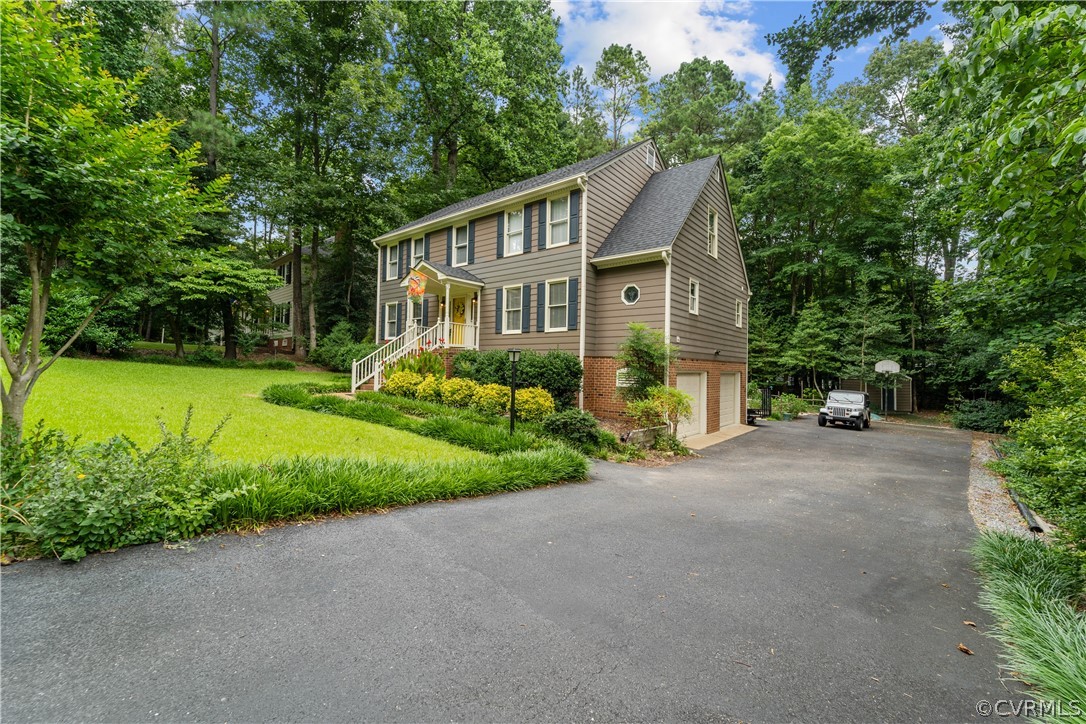 5609 North Chase Road Midlothian, VA 23112 - Photo 42 of 43 a front view of a house with a yard and trees