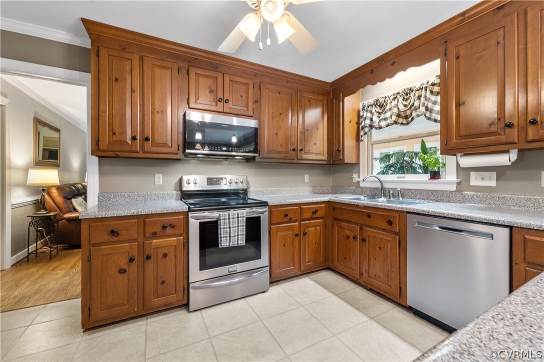 5609 North Chase Road Midlothian, VA 23112 - Photo 6 of 43 a kitchen with stainless steel appliances granite countertop wooden cabinets a stove top oven a sink and dishwasher