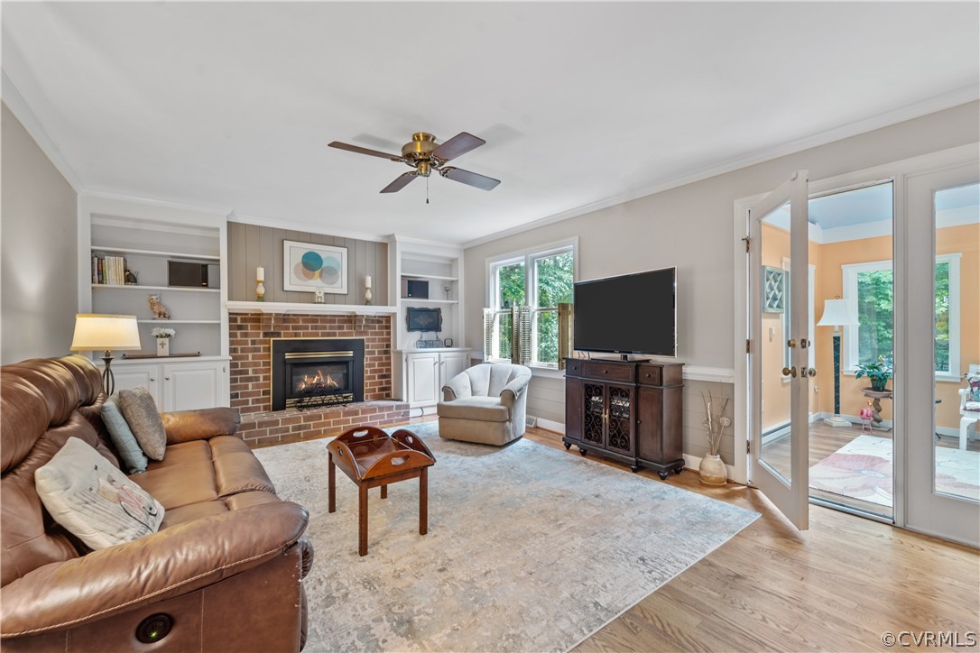 5609 North Chase Road Midlothian, VA 23112 - Photo 10 of 43 a living room with furniture a flat screen tv and a fireplace