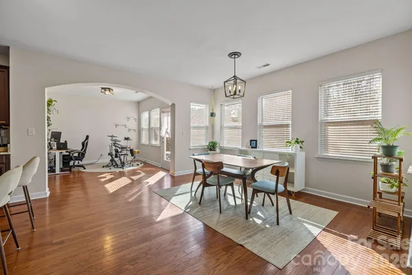 a view of a a dining room with furniture window and wooden floor