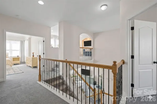 a view of a hallway with windows and stairs