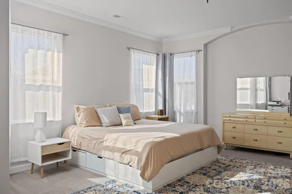 a bedroom with a bed and a dresser