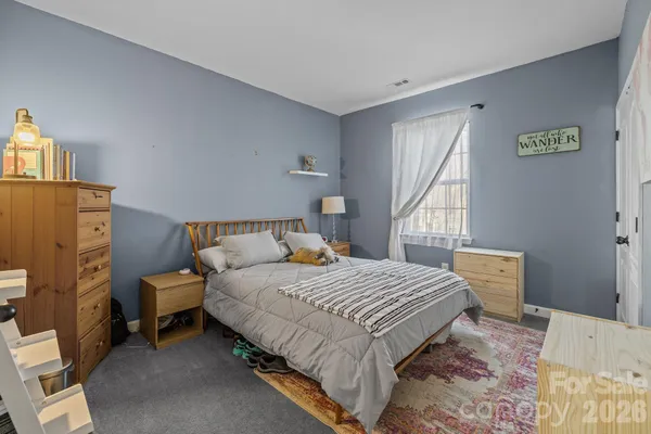 a bedroom with a bed and a table