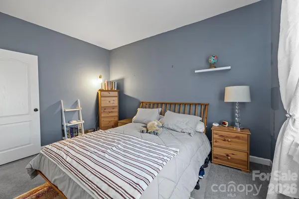 a bedroom with a bed and a lamp on table