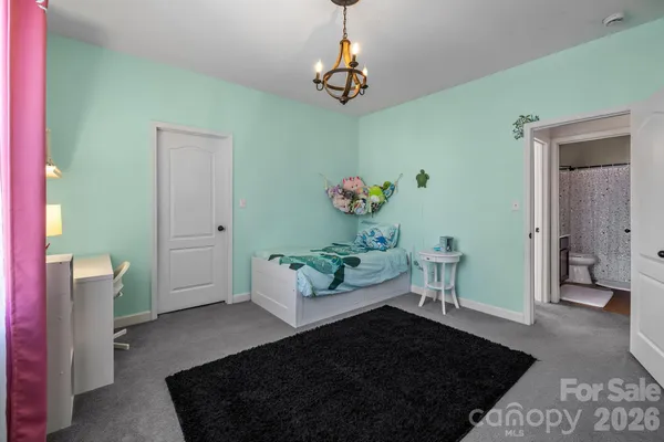 a living room with a couch and a chandelier