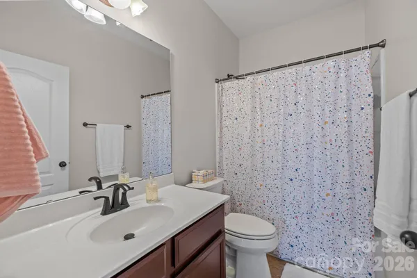 a bathroom with a sink toilet and a mirror