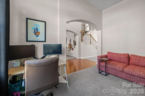 a living room with furniture and a mirror