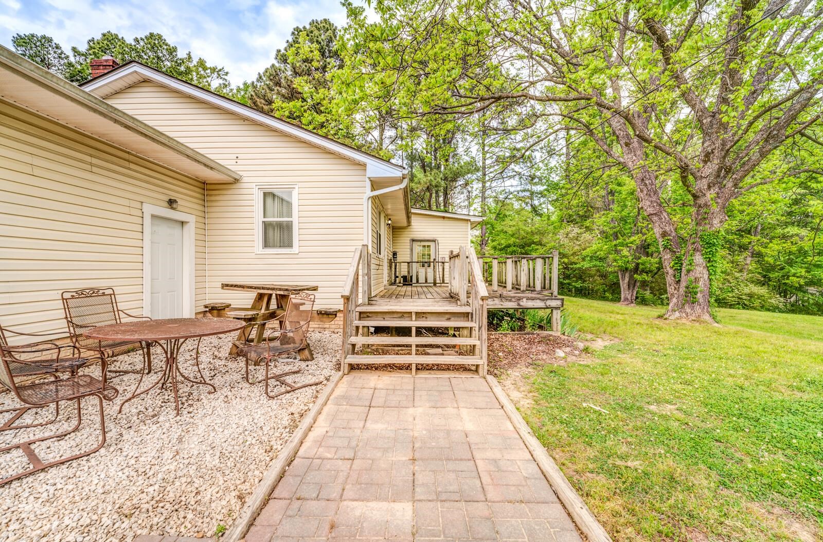 6125 Warren Road Oakland, TN 38060 - Photo 36 of 40 Cream-colored siding exterior featuring a multi-level wooden deck and a paved walkway