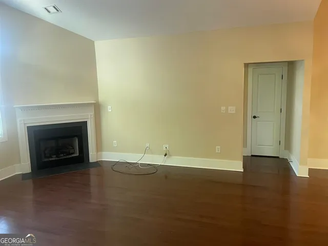 a view of an empty room with a fireplace