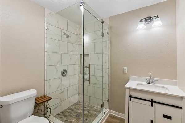 a bathroom with a sink toilet and shower